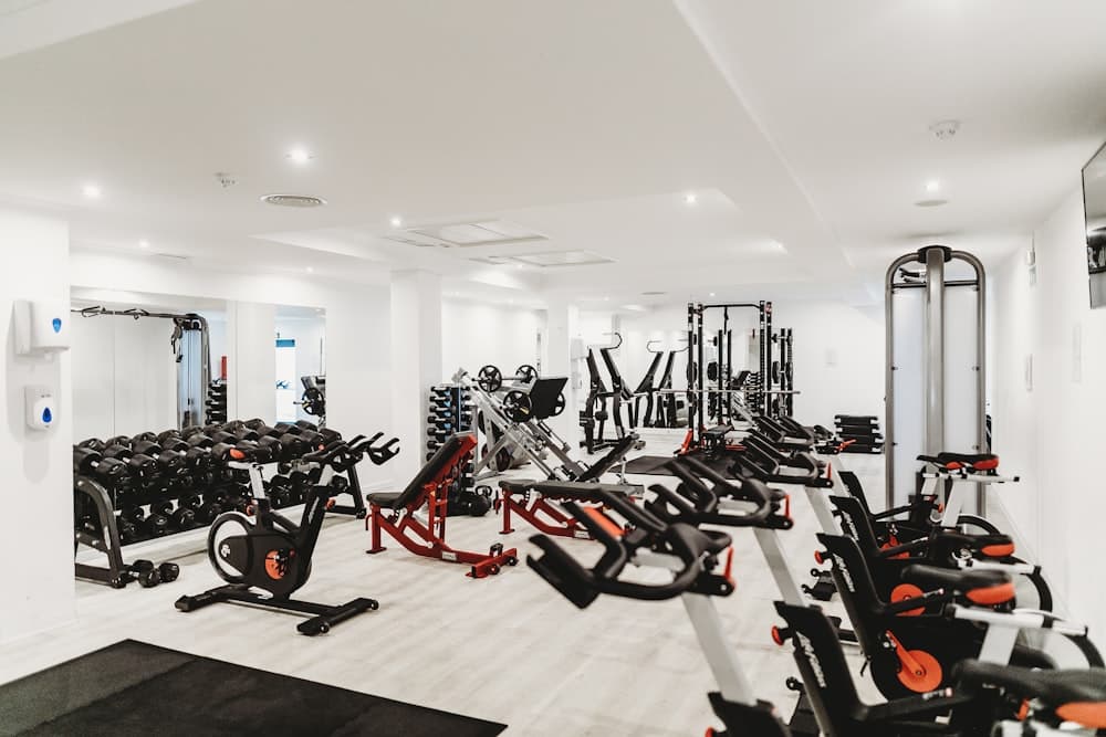 Bright modern gym floor with racks and equipment for workout programming