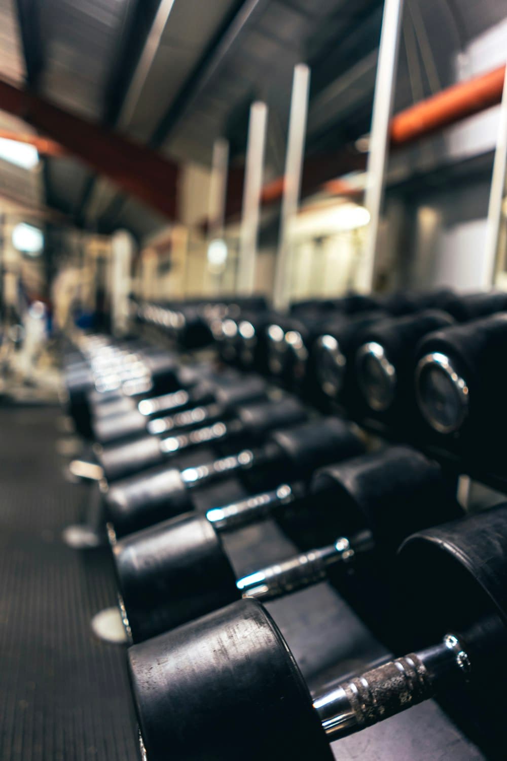 Rows of dumbbells in a gym for the client hub and check-ins